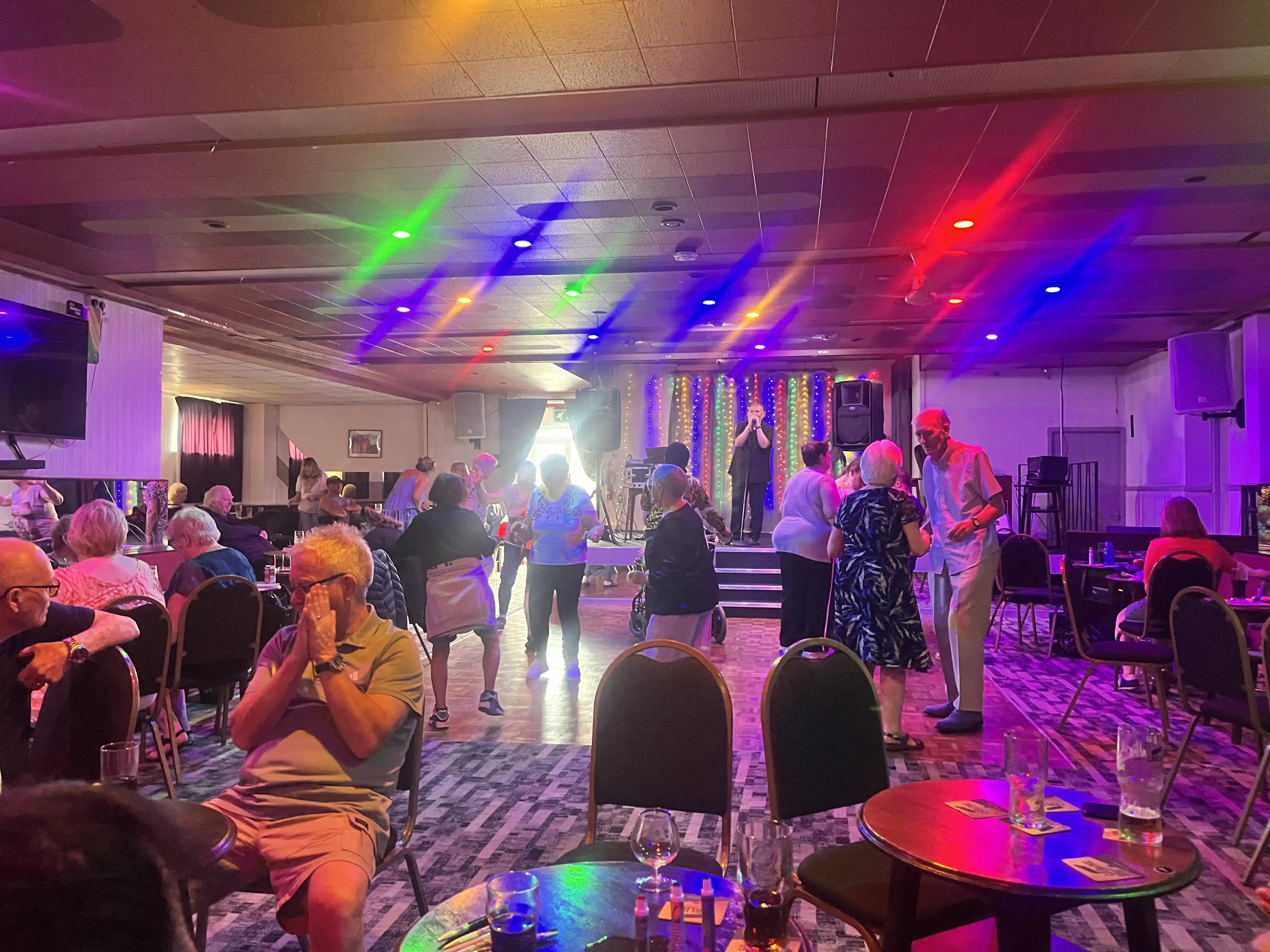Diverse members singing and dancing at Bingo
