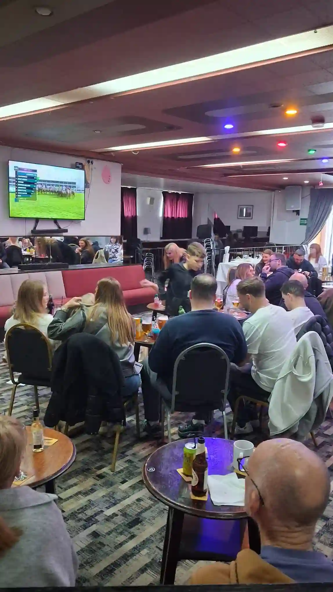 Members watching the Grand National together at the club